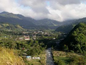 Boquete arial view with river in foreground and clouds and mountains in background – Best Places In The World To Retire – International Living